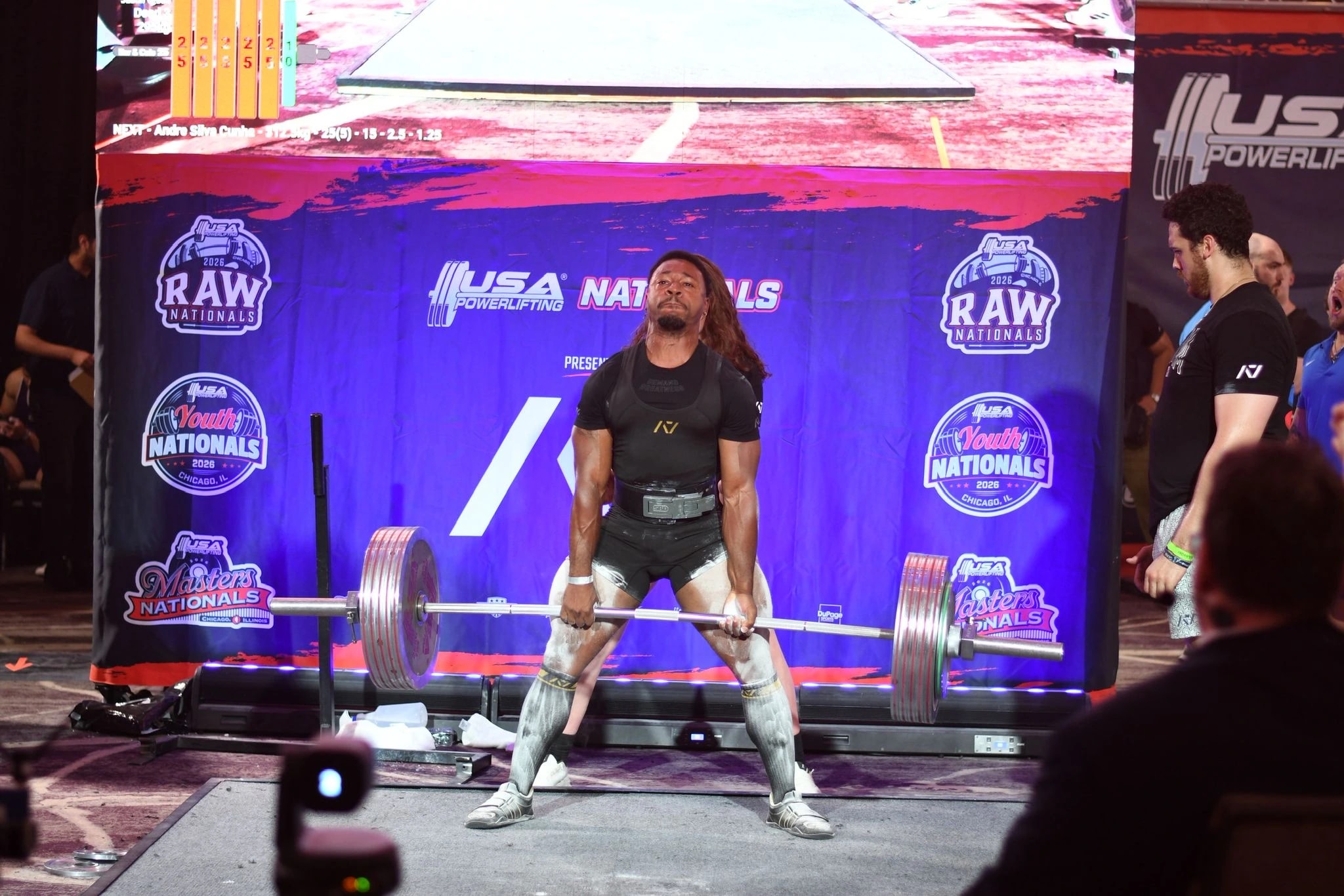 A Forte Strength athlete locking out a deadlift on the platform at USA Powerlifting Raw Nationals